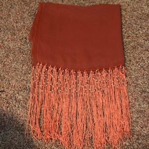 A dark pink-orange scarf